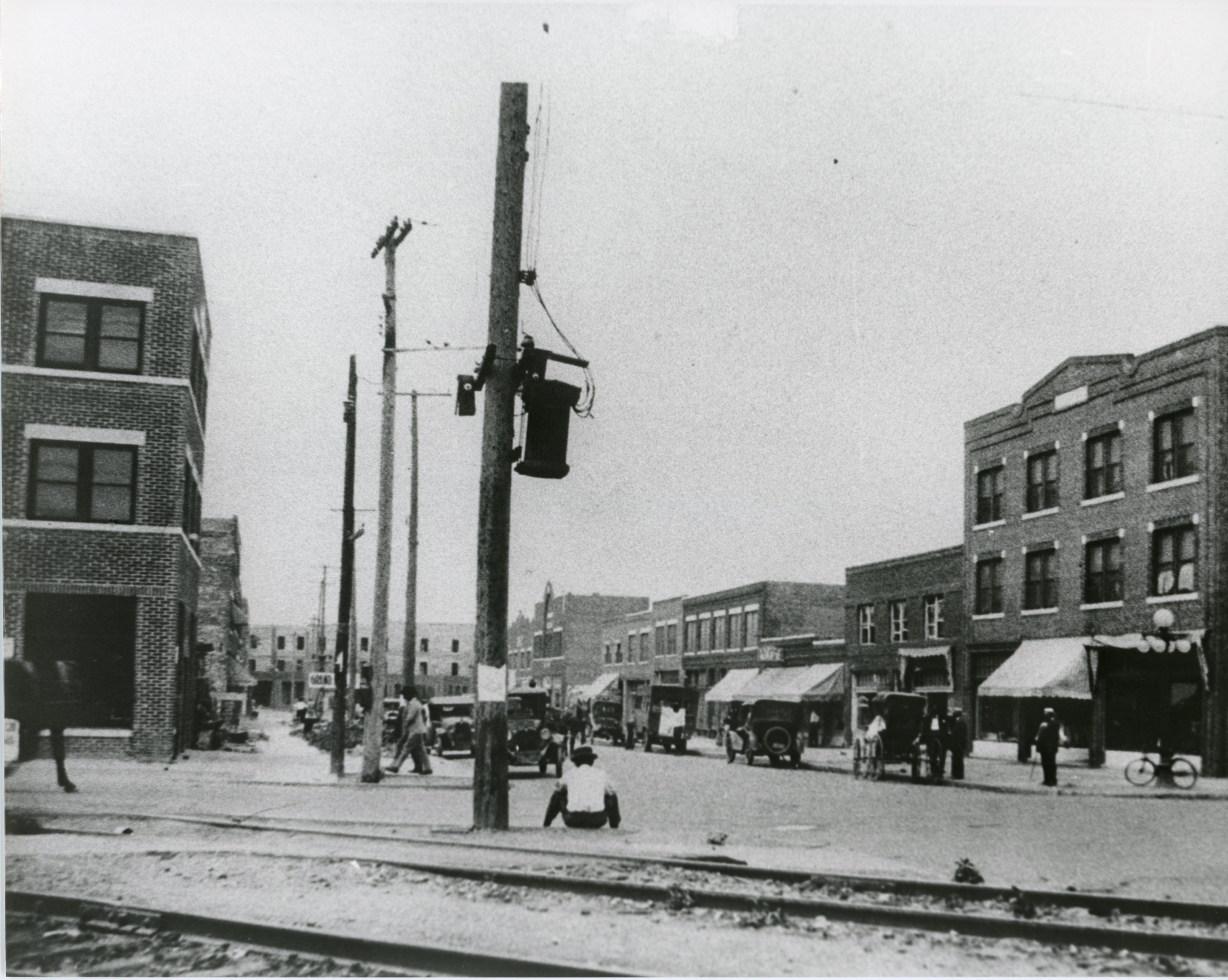 Greenwood Avenue in Tulsa after the reconstruction of the Greenwood District after the 1921 Tulsa Race Massacre. The three-story, brick Botkin Building is visible on the far right. It replaced a two-story brick building that stood before the massacre. The building on the far left is the reconstructed Williams Building completed in 1922.