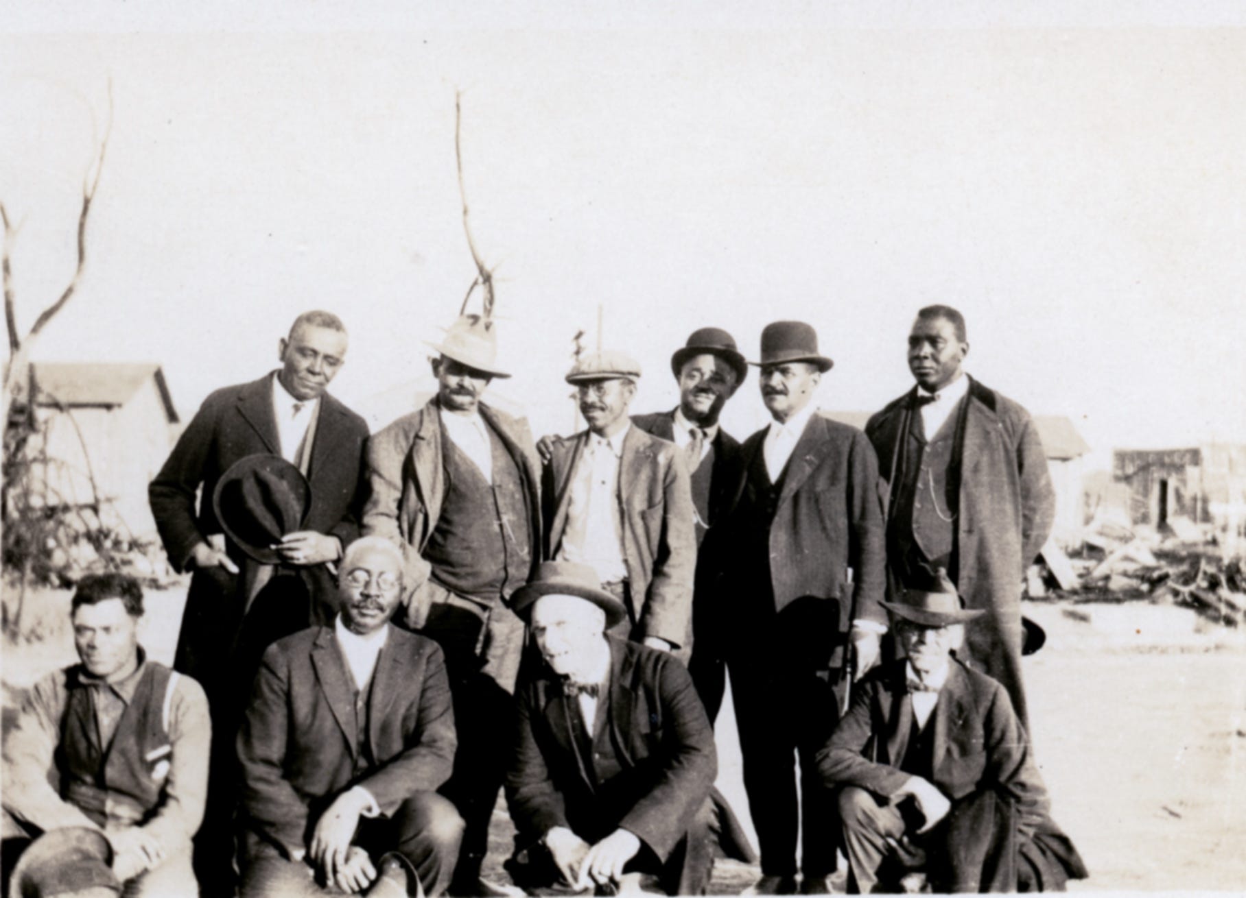 The members of the Colored Citizens Relief Committee and East End Welfare Board following the 1921 Tulsa Race Massacre.  The individuals standing include (left to right) Williams, Phillips, Esta "Essie" A. Loupe, Reverend E.N. Bryant, Horace T. Hughes and McLean. The men kneeling include (left to right) Perry Russell, O.W. Gurley, Bush, and Tucker Gilmer.