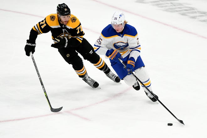 Bruins newcomer Taylor Hall, left, gives chase to Sabres defenseman Rasmus Dahlin during the first period Tuesday night at TD Garden.