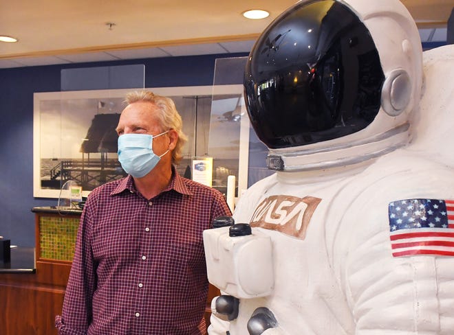 Tom Williamson, president of Cocoa Beach Area Hotel and Lodging Association, stands next to an astronaut mannequin at one of his company's hotels, the Hampton Inn in Cocoa Beach. Williamson said he expects Thursday's scheduled SpaceX Crew-2 launch to keep the momentum going for the local tourism industry, after a strong spring break. - 8396855b 922b 4cc4 97a3 360d611894e6 Crewed Space Launch Boosts Local Businesses 1 - Space Coast tourism expects boost from SpaceX launch of astronauts