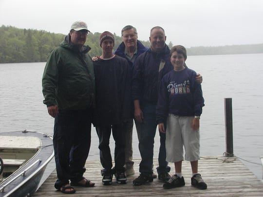 Gary Marple with his sons and grandsons on a fishing trip.