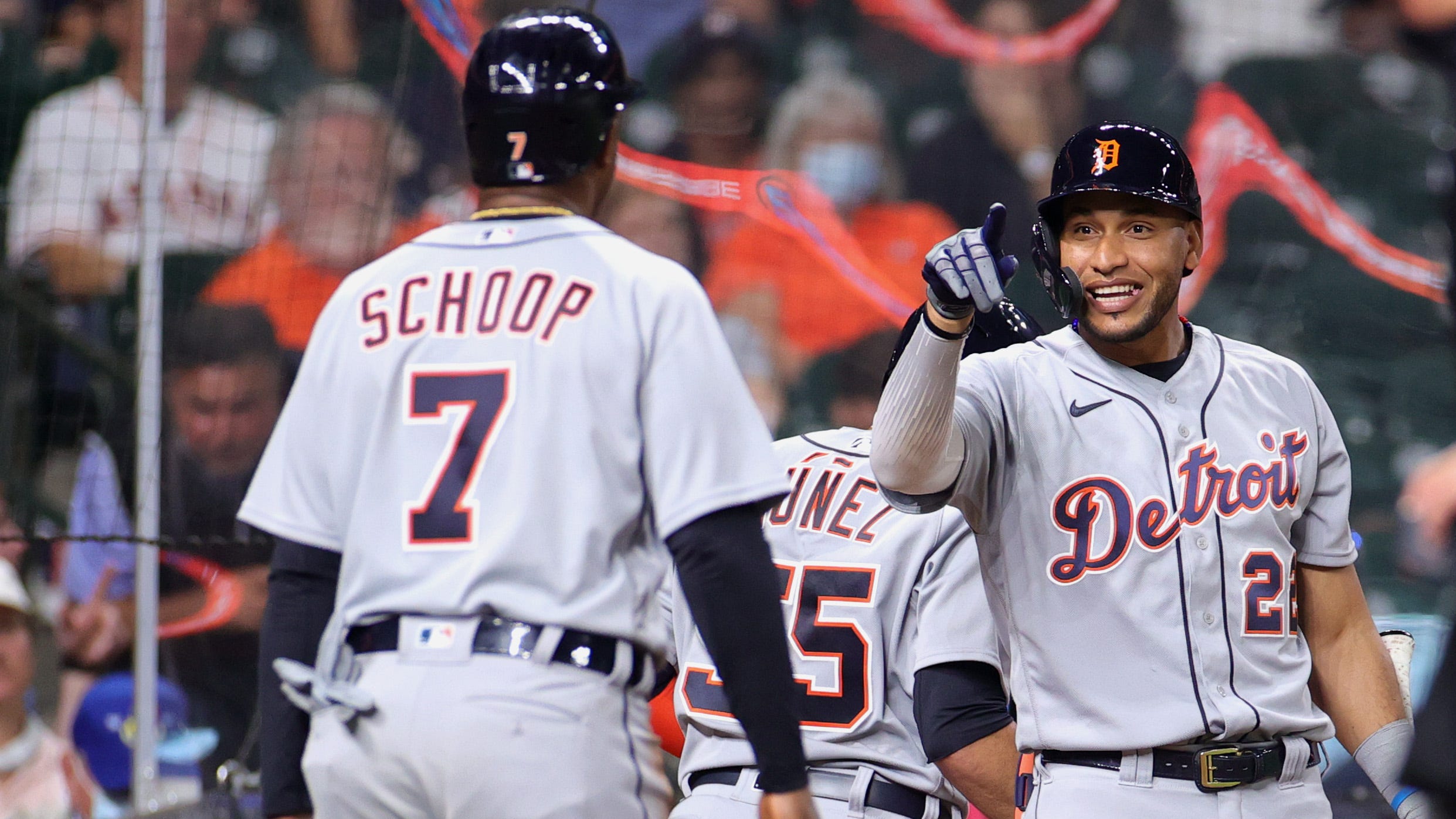Victor Reyes #22 of the Detroit Tigers reacts with Jonathan Schoop #7 during the fourth inning against the Houston Astros at Minute Maid Park on April 13, 2021 in Houston, Texas.