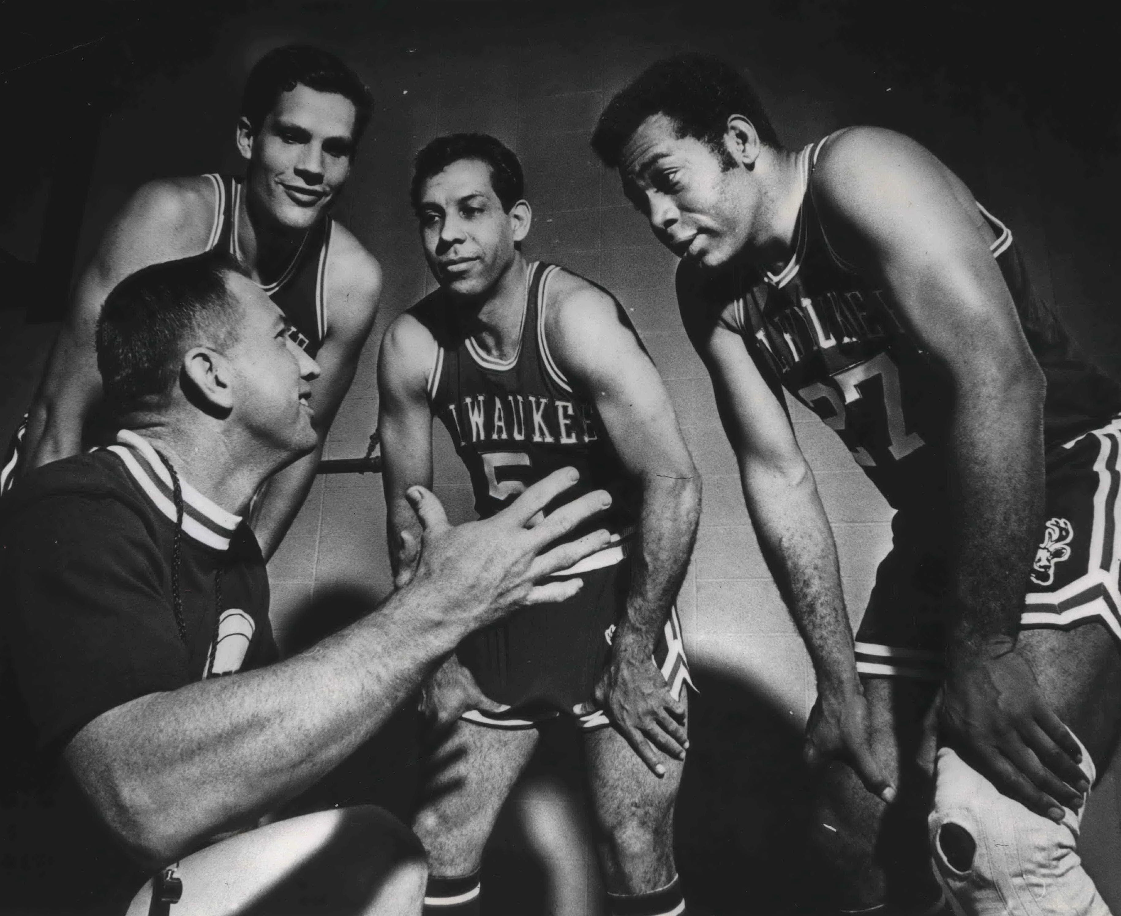 Coach Larry Costello, kneeling, talks with, from left, Fred Hetzel, Guy Rodgers and Wayne Embry as the Milwaukee Bucks opened training camp in Milton.