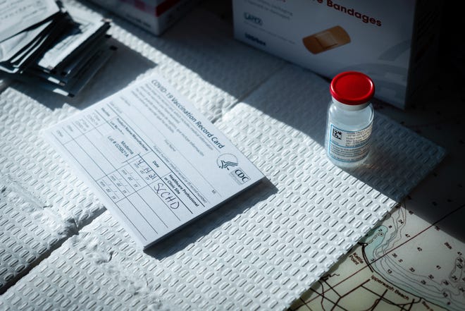A vial of a COVID-19 vaccine sits on a table during a clinic Wednesday, April 14, 2021, at the Great Lakes Maritime Center in Port Huron. Organizers of the clinic expected about 135 participants.