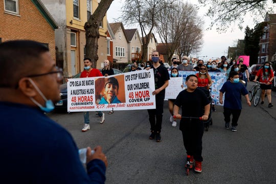 Members of Chicago's Little Village Community Council march on Tuesday, April 6, 2021 to protest against the death of 13-year-old Adam Toledo, who was shot by a Chicago Police officer at about 2 a.m. on March 29 in an alley west of the 2300 block of South Sawyer Avenue near Farragut Career Academy High School.