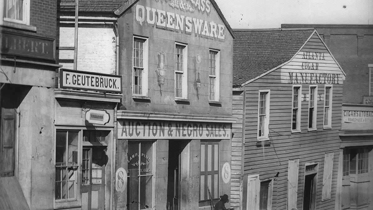 This Auction and Negro Sales  house is a Whitehall street scene in Atlanta, GA, circa 1864.
