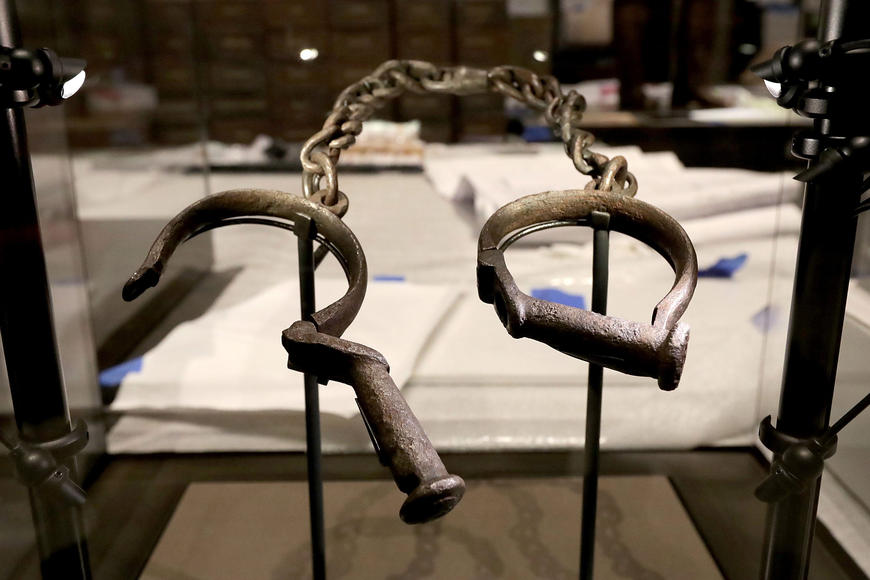 A pair of slave shackles on display in the Slavery and Freedom Gallery in the Smithsonian's National Museum of African American History and Culture. Columnists Alexander and Turner draw a line between the country's legacy of slavery and the current need for reparations.