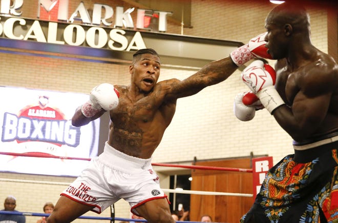 Deon Nicholson, left, knocks out Mengistu Zarzar during the Alabama Boxing Hall of Fame card at The Tuscaloosa River Market Friday, May 25, 2018.