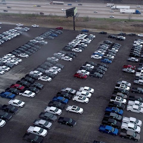 New Ford F-150 pickup trucks sit on a lot of the D