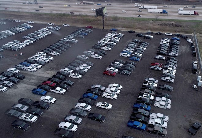 New Ford F-150 pickup trucks sit on a lot of the Department of Public Works rail yard off I-96 near Evergreen in Detroit on April 15, 2021. The trucks are waiting for semiconductors, the company said. Trucks will get quality checks done before being shipping to dealers.