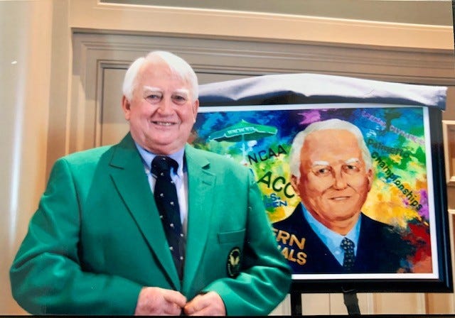 Carey Alexander Washington wearing his tennis official jacket in front of a portrait honoring his 2010 induction into the South Carolina Tennis Hall of Fame.