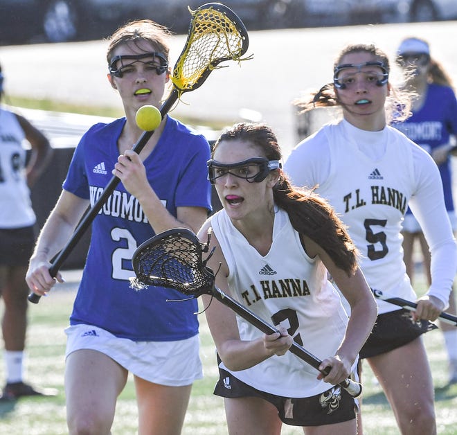 TL Hanna junior Hailey Hatch catches a loose ball near Woodmont middle Lauren Brzozowski(2) during the first half of the lacrosse match in Anderson Thursday, April 15, 2021. 
