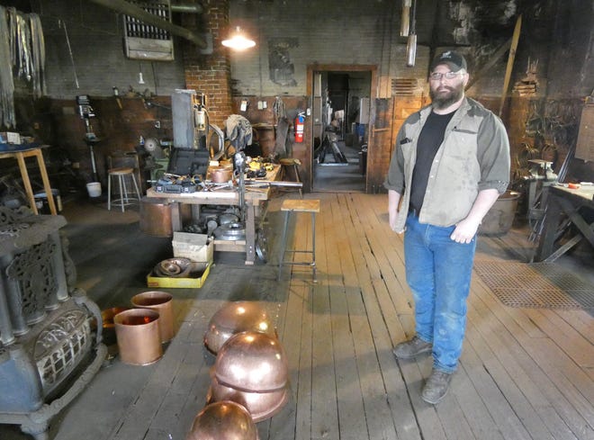 James Patrick, owner of Bucyrus Copper Kettle Works, stands in the finishing room on the building's second floor.
