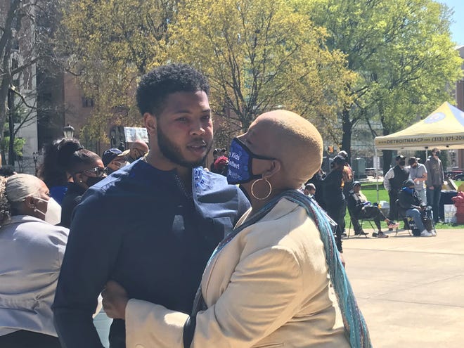 Rep. Jewell Jones, D-Inkster, receives a hug from Rep. Cynthia Johnson, D-Detroit, during a rally at the Michigan Capitol on Tuesday, April 13, 2021.