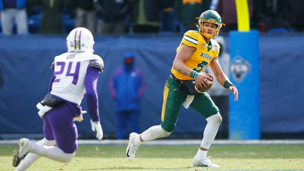 North Dakota State Bison quarterback Trey Lance (5) scrambles from James Madison Dukes safety D'Angelo Amos (24) in the third quarter at Toyota Stadium.
