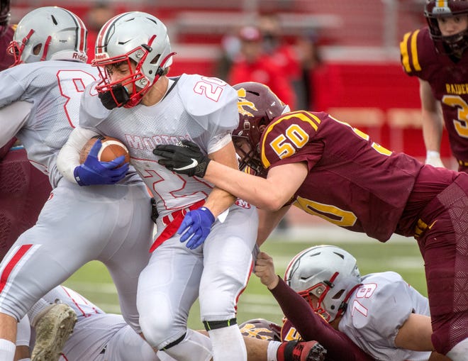 Morton running back Seth Glatz tries to get past East Peoria’s Brodie Windell in the first half during a game in the spring.