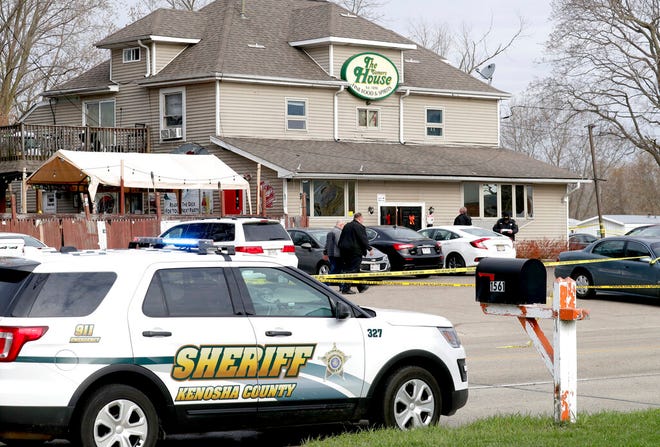 Officials investigate the scene a deadly shooting at Somers House Tavern in Kenosha, Wis., Sunday, April 18, 2021. Several people were killed and two were seriously wounded in a shooting at the busy tavern in southeastern Wisconsin early Sunday, sheriff's officials said. (Mike De Sisti/Milwaukee Journal-Sentinel via AP)