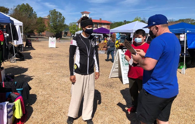 On the left, Daoist priest Alex Bechtold of Little Creek Kung Fu shares information about his school, temple and community who work for the general health and wellbeing of their members during the River Street Market