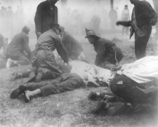 Rescue workers aid fire victims at the Ohio State Penitentiary in Columbus, Ohio, on April 21, 1930. More than 300 persons, mostly inmates, perished in the fire. 