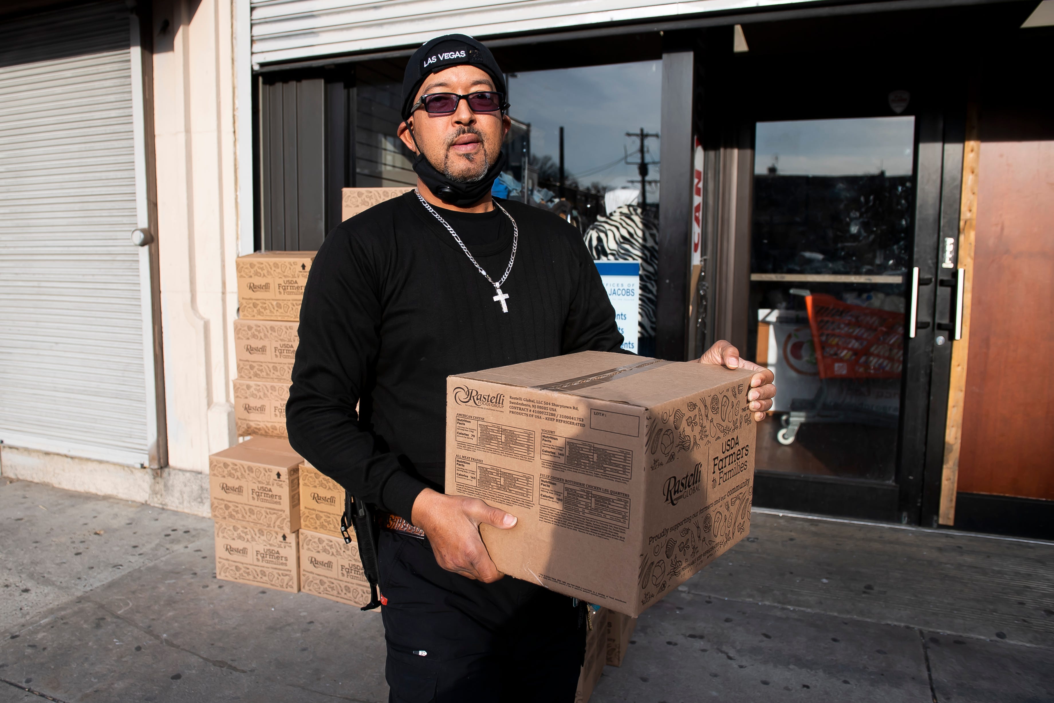 Rodney Gregory carries a box full of food to his car after stopping by a food bank in North Philadelphia on Monday, April 5, 2021. Gregory took one box for his family and a second box for one of his neighbors that he helps out.