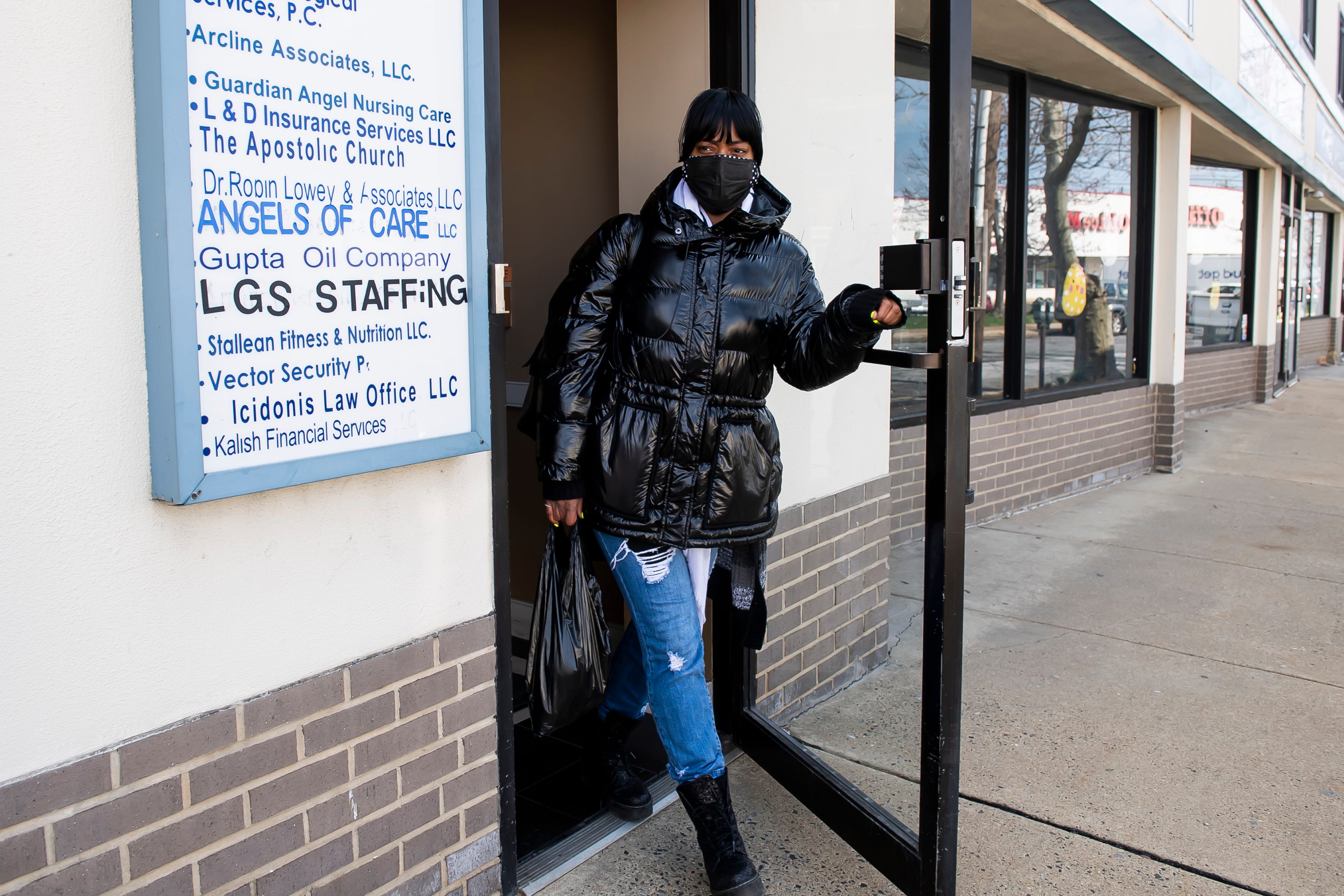 Tina Moore exits a retail office building after dropping off her rent check for the month in Mayfair, Philadelphia on Thursday, April 1, 2021.