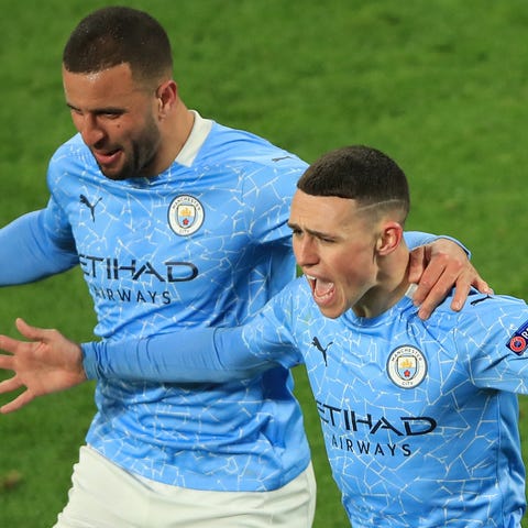 Manchester City's Phil Foden (right) celebrates af