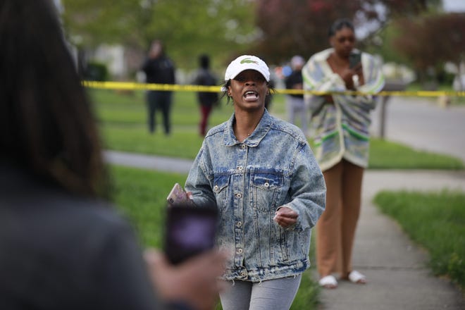 Shanise Washington talks to the crowd that had gathered on Legion Lane on Columbus' Southeast Side following a fatal shooting by a city police officer responding to an attempted stabbing call.