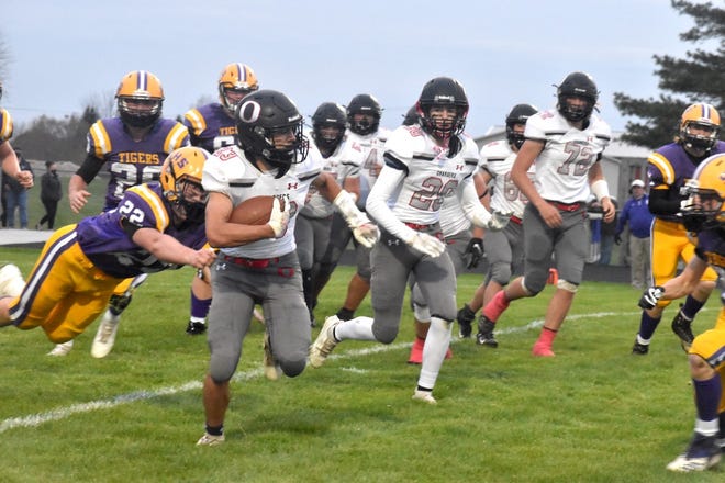 Charger Cole Kratzberg (23), far left, runs for a first down early in the second quarter of the varsity game with the Tigers on Friday, April 16, in Sherrard. Also in on the play are, in front from left, Blayden Murdock (20) and Jayson Johnson (72), and in back Kale Stropes (57) and Nolan Loete (62).