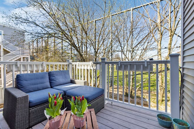 The home's Trex deck is just off the kitchen. With a park next door, the views of nature are plentiful.