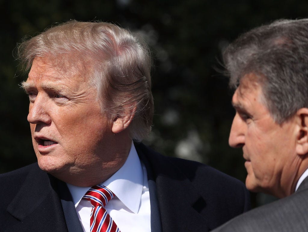 President Donald Trump talks with Sen. Joe Manchin during an event to honor the 2017 NCAA Football National Champion Alabama Crimson Tide at the White House on April 10, 2018.