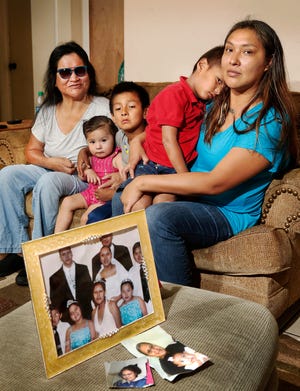 Ida Beard disappeared in the summer of 2015, at the age of 29. Her mother, Rebecca Ponkilla, left, and a sister, Zina Deere, right, continue to search for answers to why she went missing and still seek clues about her well-being and whereabouts. They are shown during an interview in Deere's home in southeast Oklahoma City on Tuesday, July, 9, 2019. Deere is holding her son, Nathaniel, 4. Her older son, Ezekial, 6, is holding Ida's granddaughter, Aileen Beard, 1. Family photo in foreground was taken on Deere's wedding day. Ida is shown in the front row, center.
