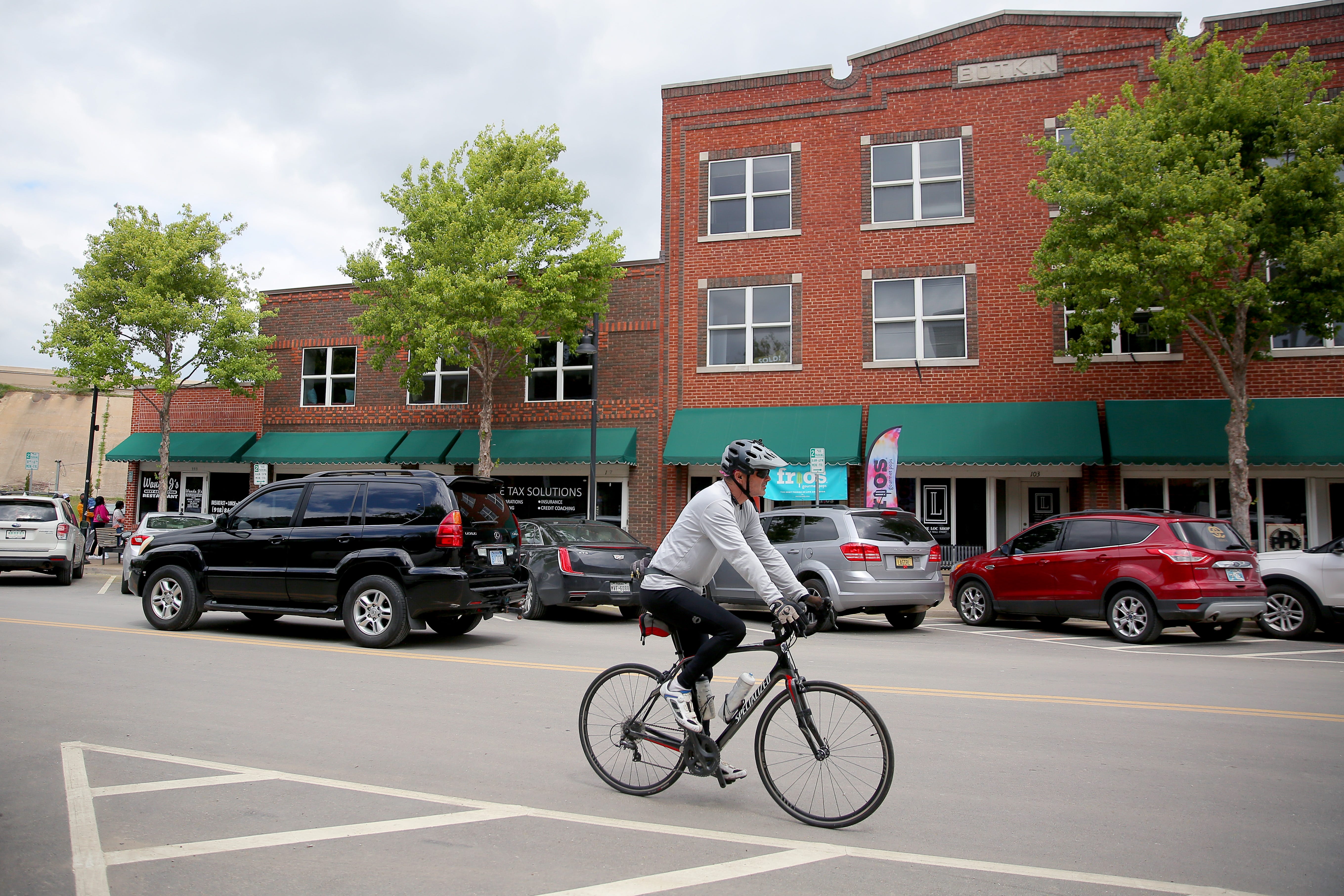 A bicyclist rides along Greenwood Avenue, the only block of the district rebuilt in 1920s after the massacre to survive a second wave of destruction in the 1960s.