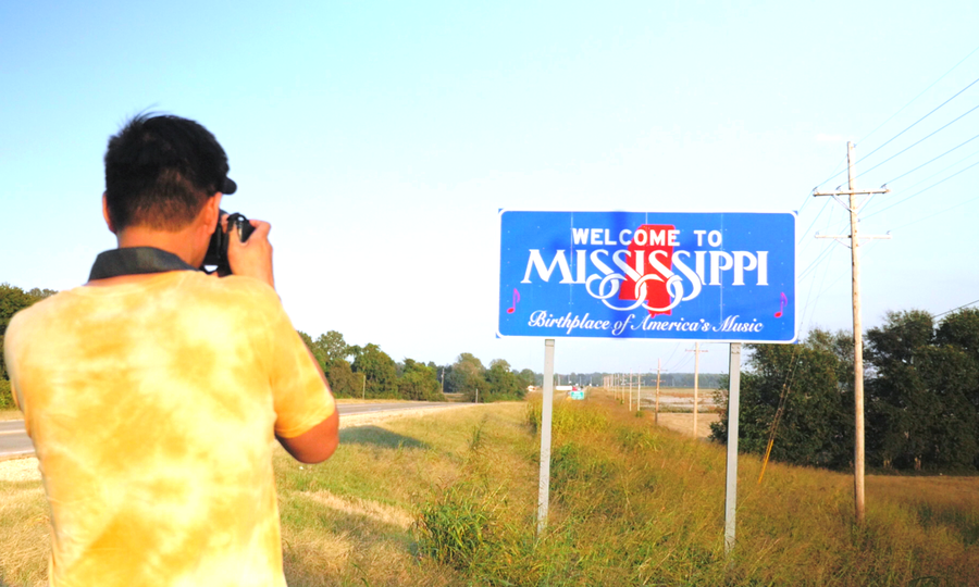 Baldwin Chiu, producer and lead subject in the documentary "Far East Deep South" takes of picture of the Mississippi border.