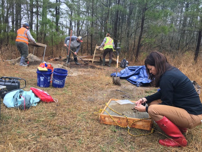 Dr. Julie Schablitsky examines artifacts found at the home of Harriet Tubman's father