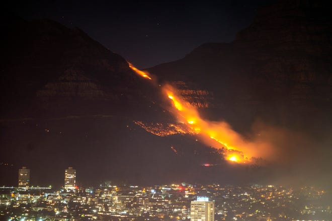 Wohnviertel werden am 19. April 2021 in Kapstadt, Südafrika, von wütenden Bränden angezündet. Die Bewohner werden aus Kapstadt evakuiert, nachdem ein großes Feuer, das sich an den Hängen des berühmten Tafelbergs der Stadt ausbreitet, über Nacht von starken Winden angefacht und bedroht wurde Häuser.
