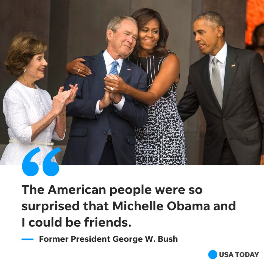 Former first lady Michelle Obama hugs former President George W. Bush as former first lady Laura Bush and former President Barack Obama look on.