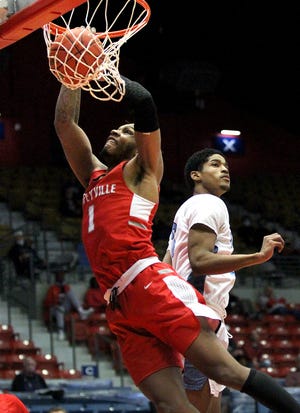 Coffeyville's Larry White (1) dunks the ball past Odessa's Shaman Alston (3) during their NJCAA Men's Div. I Basketball Championship Tournament Tuesday at the Sports Arena. Coffeyville defeated Odessa 95-56.