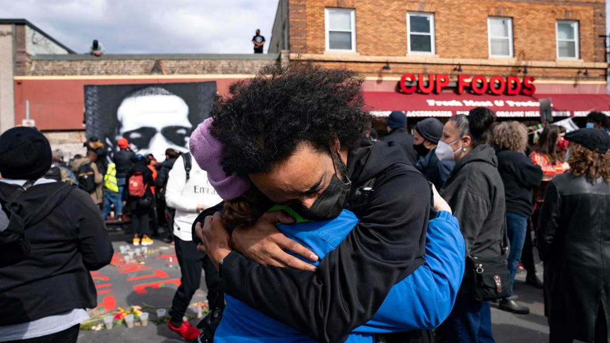 Nic Hernandez and Emma Ruddock hug in celebration after hearing the verdict of Derek Chauvin at George Floyd Square on April 20, 2021.