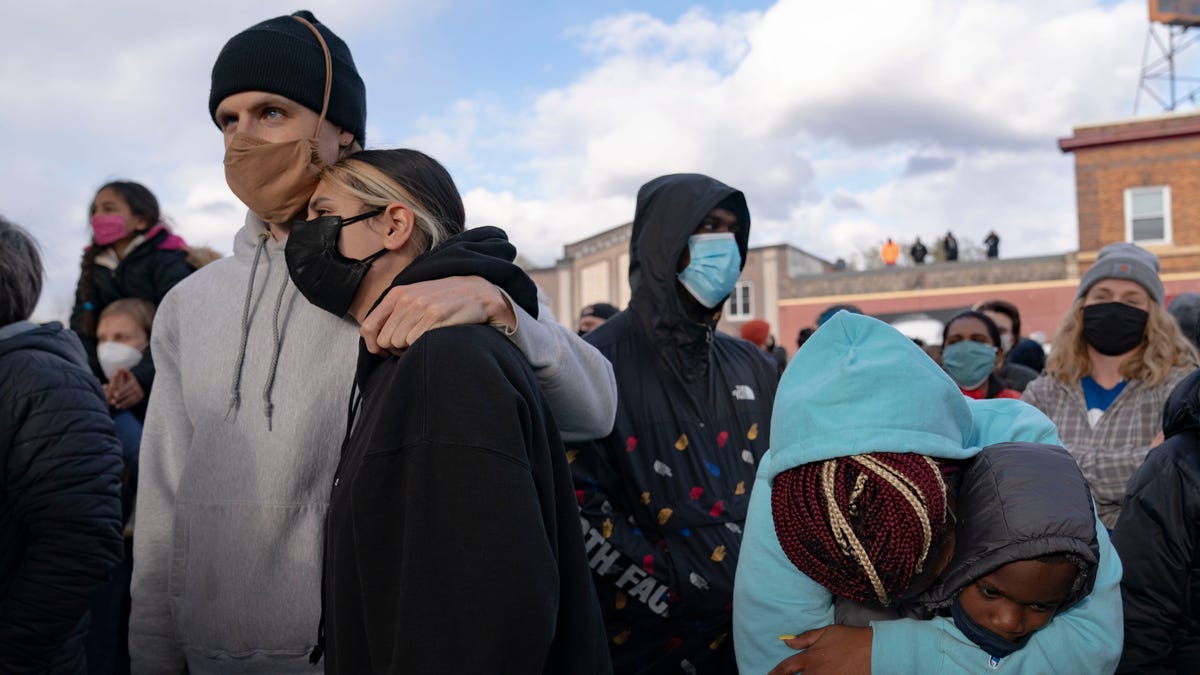 Minneapolis residents Matt Lawler and Elliana Carrera, left, and Ashley Davis and her son David Ramsey Jr. embrace after hearing the verdict of Derek Chauvin at George Floyd Square on April 20, 2021.