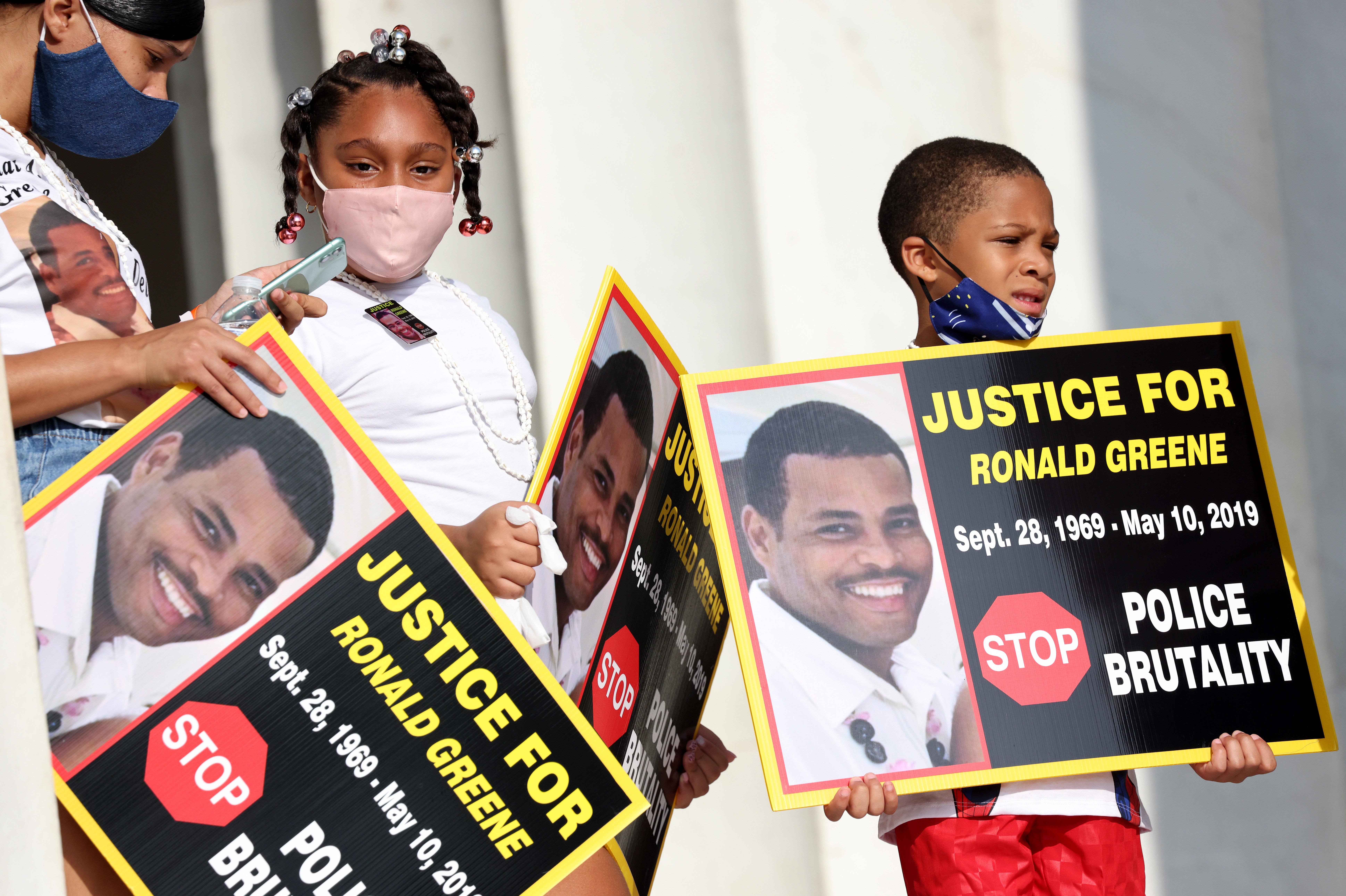 Family members of Ronald Greene listen to speakers as they gather at the Lincoln Memorial for the March on Washington August 28, 2020 in Washington, D.C. A police video — not yet made public — reportedly shows Greene being tased before his 2019 death at least 3 times over 20 seconds and again as he lay on his belly before he was hog-tied, shackled, beaten and dragged.