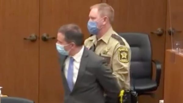 Derek Chauvin is led out of the courtroom in handc