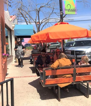 Chef Ryan Parrott walks food out to sidewalk diners at Picasso's Cafe in Oklahoma City's Paseo Arts District.