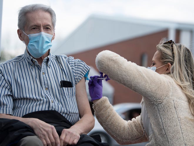Barry Cline, of Portland, Tennessee, receives a COVID-19 vaccine from Chelsea Angel of Adhere Rx at a pop-up vaccination clinic on April 22, 2021. Vaccinations are lagging across Tennessee, but especially in rural areas like Portland.
