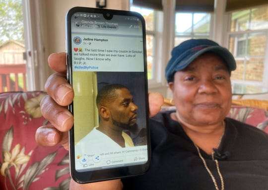 Glenda Brown Thomas displays a photo of her nephew, Andrew Brown Jr., on her cellphone on Thursday.