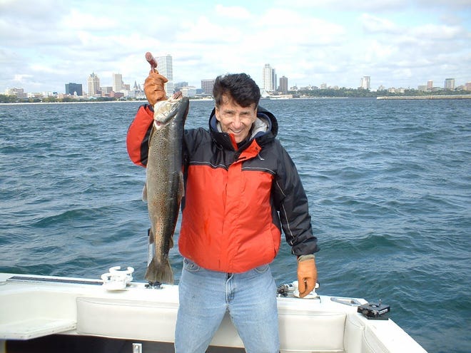 Ed Kaizer holds up a prize catch during a charter fising trip on Lake Michigan. Music wasn’t Kaizer’s only passion - he was also an avid fisherman.