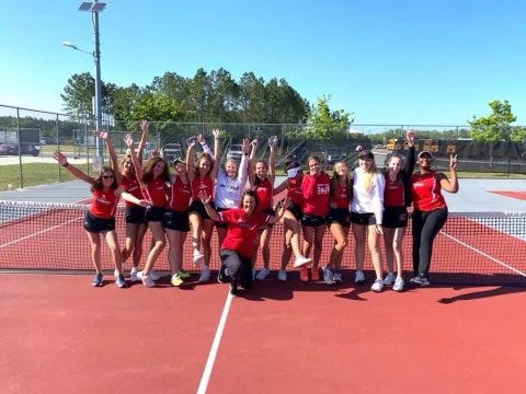 Creekside High girls tennis team celebrates after defeating Flagler Palm Coast in the regional finals Thursday.