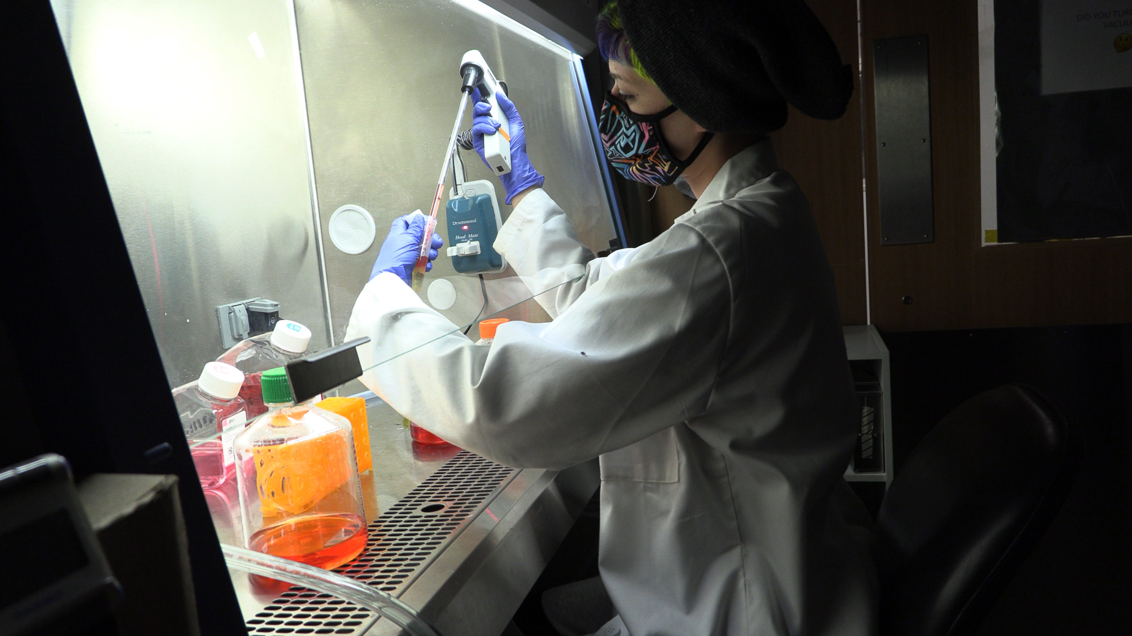 Lena Labdi, a research assistant at the University of Massachusetts Medical School, working in the Sena-Esteves lab on April 13, 2021, in  Worcester, Mass.