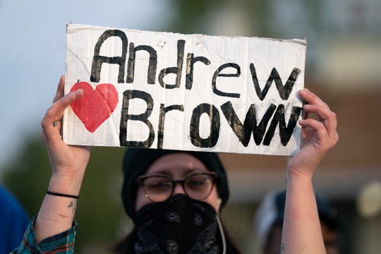 A demonstrator holds a sign for Andrew Brown Jr. during a protest march on April 22, 2021 in Elizabeth City, North Carolina. The protest was sparked by the police killing of Brown on April 21.