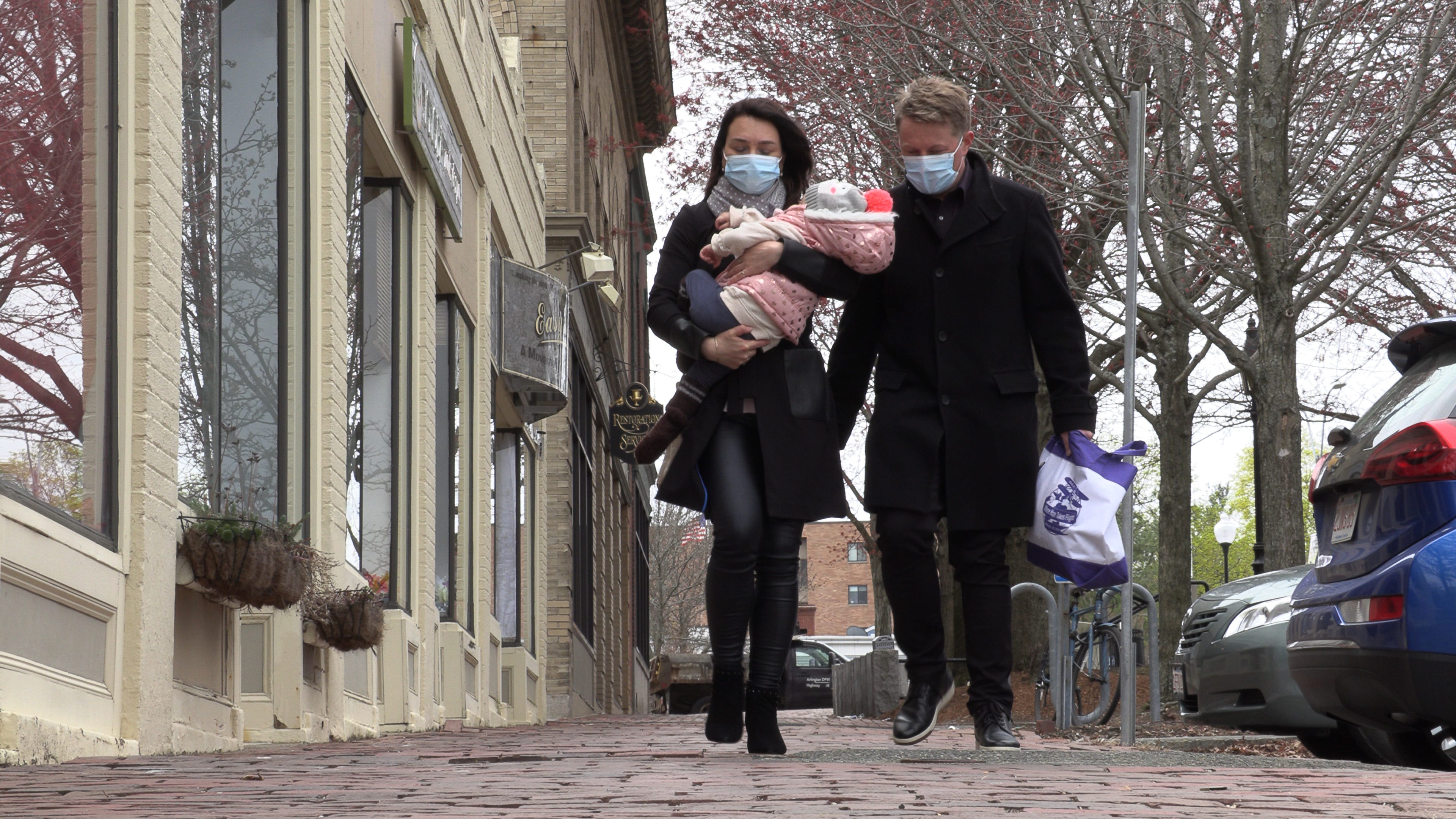 Thomas Feldborg and wife Daria Rokina carry their daughter Alissa Rokina Feldborg, 16 months old, home from a therapy session on April 13, 2021 in Arlington, Mass.