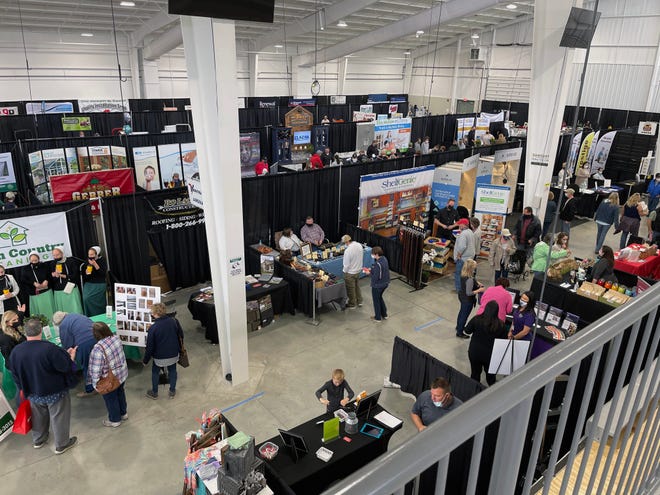 Attendees visit vendors at a home and garden show.